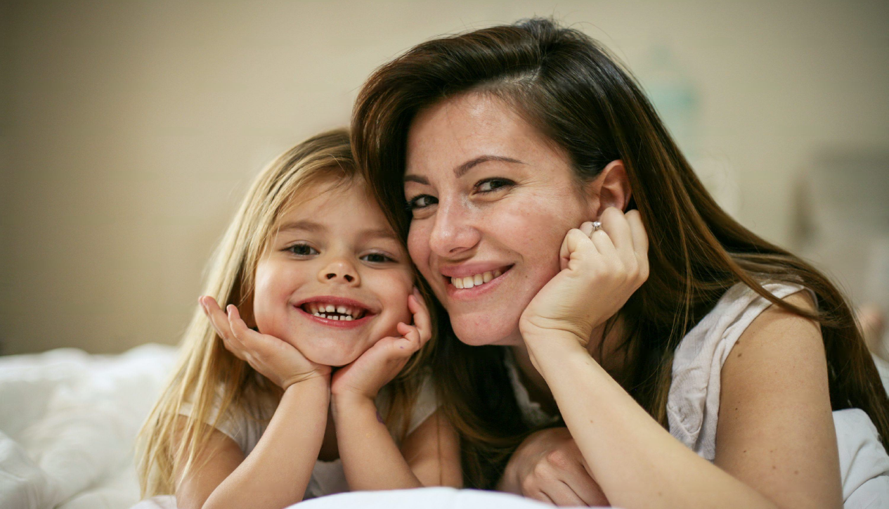 Mother and daughter smiling together